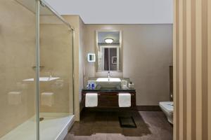 a bathroom with a sink and a tub and a toilet at Elite World Istanbul Florya in Istanbul