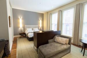 a hotel room with a large bed and a large window at Hotel Lindrum Melbourne - MGallery in Melbourne