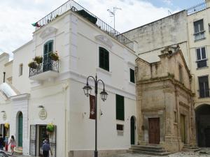 un edificio blanco con balcón en una calle en Affittacamere San Francesco, en Matera