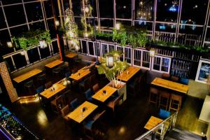 an overhead view of a restaurant with tables and chairs at THE GRAND CORAL in Bengaluru +3 photos