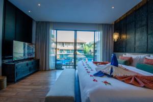 a bedroom with a large bed with a tv and a bed sidx sidx at Ananya Lipe Resort in Ko Lipe +170 photos