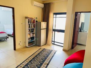 a living room with a refrigerator and a book shelf at Nilis vila הווילה של נילי in Mishmār Hāyardin