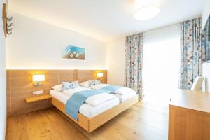 Ένα ή περισσότερα κρεβάτια σε δωμάτιο στο Hotel Loy