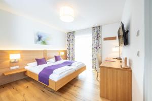 Ένα ή περισσότερα κρεβάτια σε δωμάτιο στο Hotel Loy