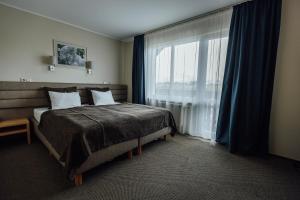 Postel nebo postele na pokoji v ubytování Spa Hotel Ezeri