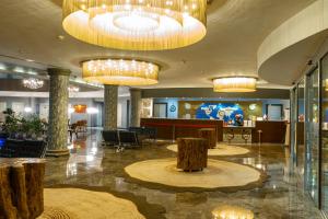 a lobby of a hotel with chandeliers at Doğa Thermal Health & Spa in Pamukkale