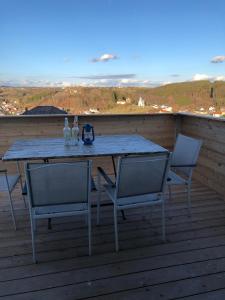 a table and chairs on a deck with a view at Landhaus Südburgenland in Olbendorf
