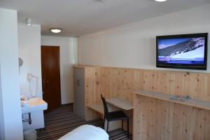 Televisor o centre d'entreteniment de Hotel Alpina nature-wellness