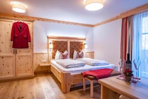 a bedroom with a bed with a wooden headboard at Landhaus Leopoldhof in St. Wolfgang +17 photos
