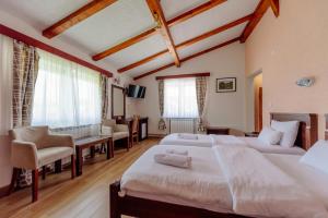 Postel nebo postele na pokoji v ubytování Hotel Zlatni bor