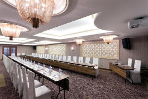 a long row of tables in a room with chandeliers at Grand Anka Hotel in Istanbul