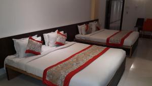Postel nebo postele na pokoji v ubytování HOTEL SAI NISARG
