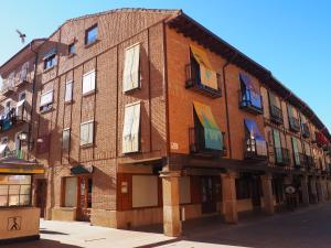 a large brick building with windows on a street at -La Olmeda- La Casona del Zoilo in El Burgo de Osma
