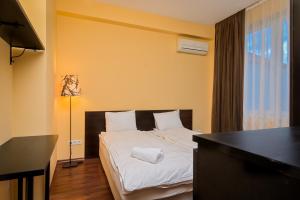 A bed or beds in a room at Glitter ~2-BDR Flat by National Palace of Culture