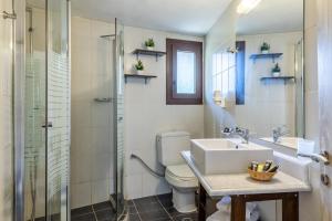 a bathroom with a sink and a toilet and a shower at Skopelos Holidays Hotel & Spa in Skopelos Town