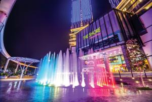 a water fountain in front of a building at night at MIO BOUTIQUE Hotel in Malacca