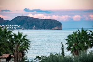 a view of a body of water with palm trees at LA MAR - Managed by Almarina in Benissa