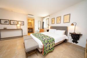 a bedroom with a large bed and a table at Domaine des Peyre in Robion en Luberon