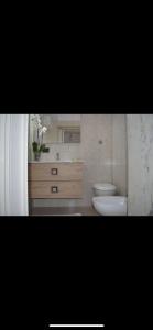 ein Badezimmer mit einem weißen WC und einem Waschbecken in der Unterkunft Casa Fronte del porto in Bari