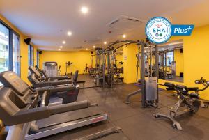 a gym with treadmills and cardio equipment in a room at Woovo Phuket Patong - SHA Extra Plus in Patong Beach