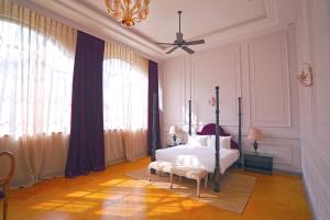 a bedroom with a bed and a ceiling fan at The Source At Sula in Nashik