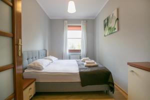 Posteľ alebo postele v izbe v ubytovaní Parkowa Polana - PolanicaApartamenty