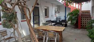 a patio with a wooden table and chairs at Can Juvimar in El Poblenou del Delta