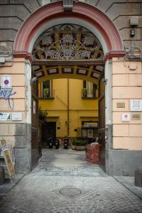 ein Eingang zu einem Gebäude mit einem Torbogen in der Unterkunft ForiArt Relais in Neapel