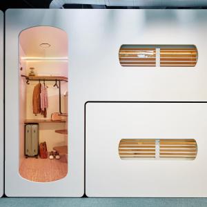 a white refrigerator with a window in a room at CityHub Copenhagen in Copenhagen