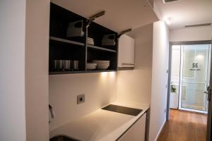 a kitchen with black cabinets and a white counter top at Grandi 32 in Segrate