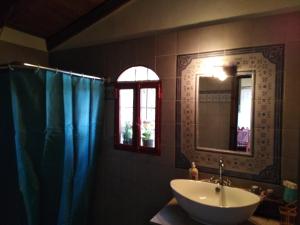 a bathroom with a sink and a mirror at ΦΙΛΥΡΑ ΠΕΤΡΙΝΟ in Kernitsa +32 photos