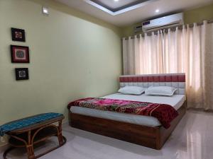 a bedroom with a bed and a table in it at Mi casa homestay in Guwahati