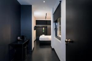 a dark room with a bed and a room with a door at Nin&Bau Sarri 2 in Athens