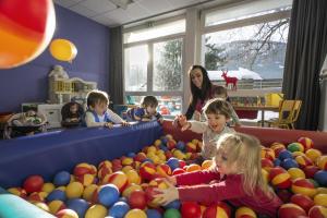 a woman and children playing in a pile of balls at Belambra Clubs Praz-sur-Arly - L'Alisier in Praz-sur-Arly