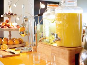 a table with a jar of orange juice on it at Novotel London Wembley in London