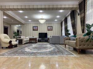 a large living room with couches and a television at Hotel City Samarkand in Samarkand