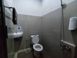 a bathroom with a toilet and a sink at Alana House Syariah in Garut +44 photos
