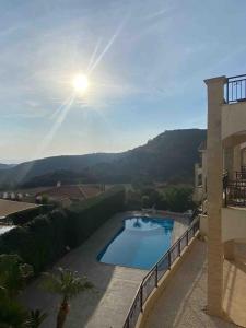 a swimming pool on the side of a building at Aphrodite Gardens in Pissouri +6 photos