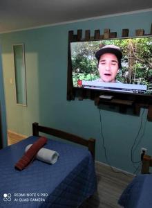 a tv on a wall in a bedroom at Casa 5-6 Personas Puerto Natales in Puerto Natales