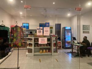 a store with a person sitting in front of a store at NASA Family Suite at Imperium Residence in Kuantan +48 photos
