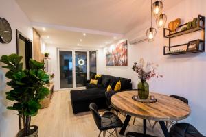 a living room with a table and a couch at BlackWood '66 Apartman in Siófok