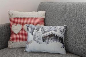 オーバータウエルンにあるAppartements Tauernblickの雪に覆われた家のソファの上の枕