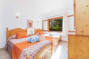 a bedroom with two beds and a window at Villa El Mal Pas / Can Seguinet in Alcudia +37 photos
