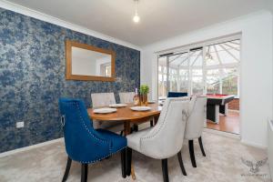 a dining room with a table and chairs at WILLIAM HOMES - COOMBE ABBEY, Free Parking, King BED, NETFLIX & Pool Table in Coventry