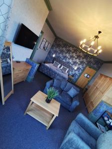 an overhead view of a living room with blue furniture at Hotel Victoria in Lowestoft