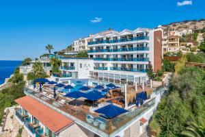 an aerial view of a resort with umbrellas and the ocean at Meis Exclusive Hotel in Kaş