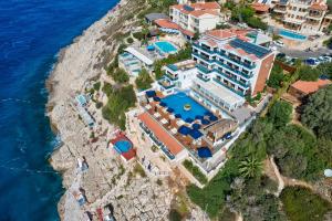 an aerial view of a resort on a cliff next to the ocean at Meis Exclusive Hotel in Kaş