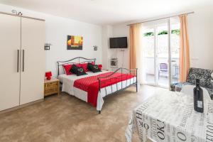 a bedroom with a bed and a tv and a chair at Apartments Veronika in Pag