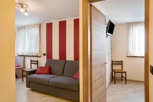 een woonkamer met een bank en een televisie bij Baita Nicoletta Red in Livigno