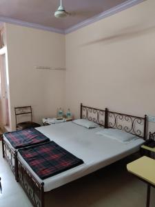a bedroom with a large bed in a room at Raj Mahal Hotel in Nagpur